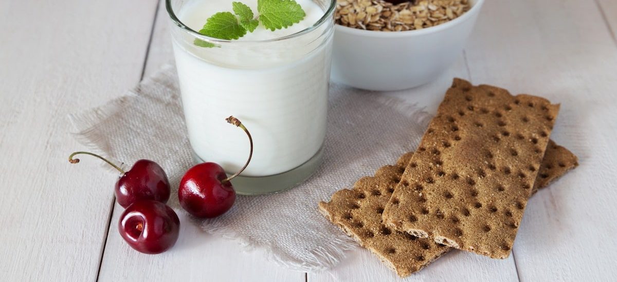Glass of yoghurt, crispbreads and cereal