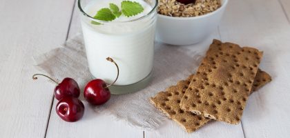 Glass of yoghurt, crispbreads and cereal