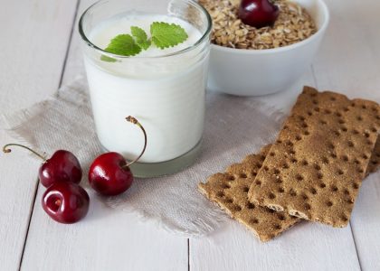 Glass of yoghurt, crispbreads and cereal